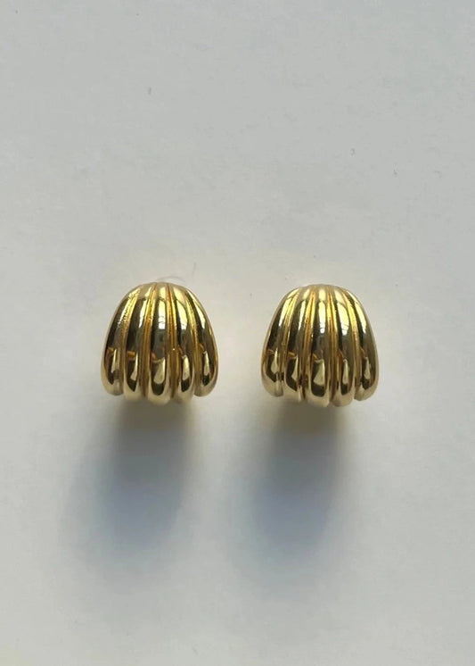 Pair of gold earrings on a light gray background