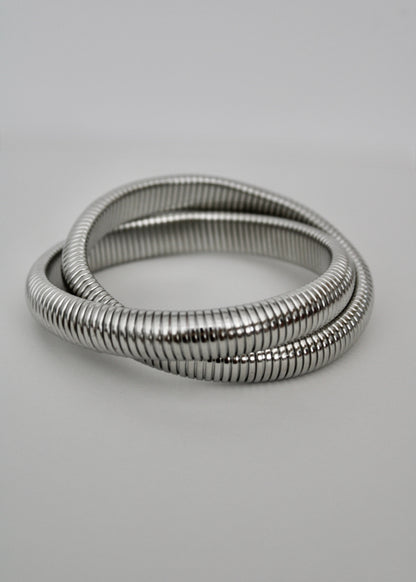 Silver bracelet on a light gray background